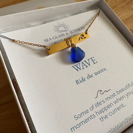 blue sea glass on gold wave bar necklace
