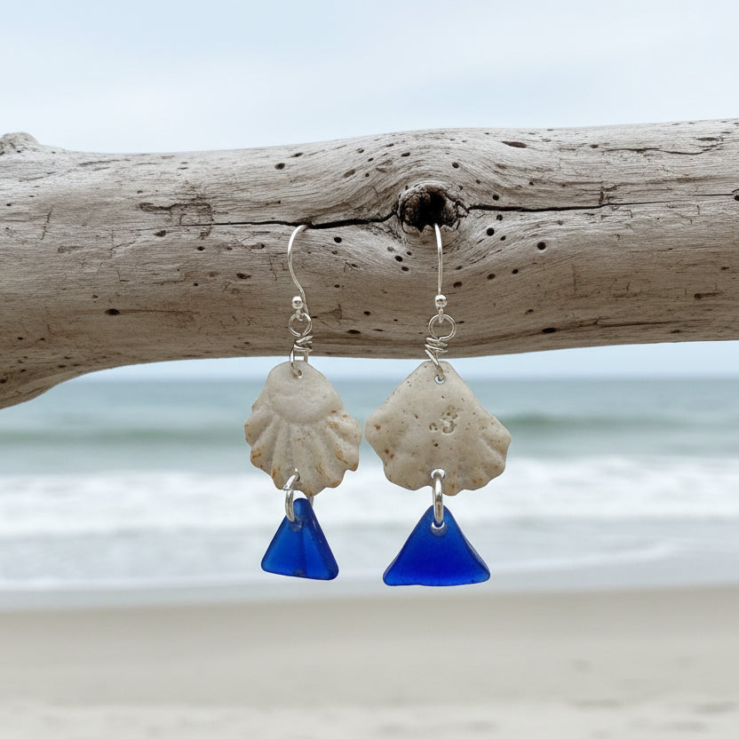 Handmade sea glass earrings on a Sea Glass & Sunsets card with a blurred outdoor background.