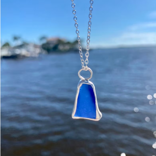 Blue sea glass pendant on a silver chain 