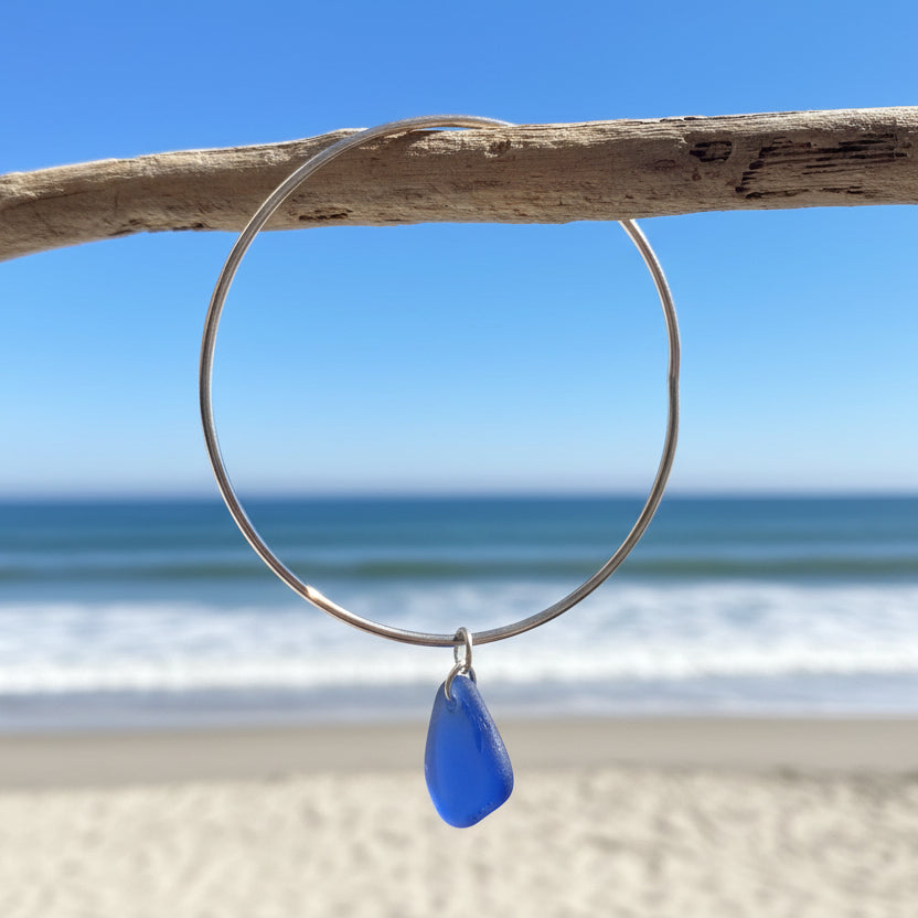 silver bangle with blue sea glass charm